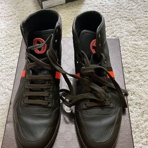 Olive green sneakers with orange stripe